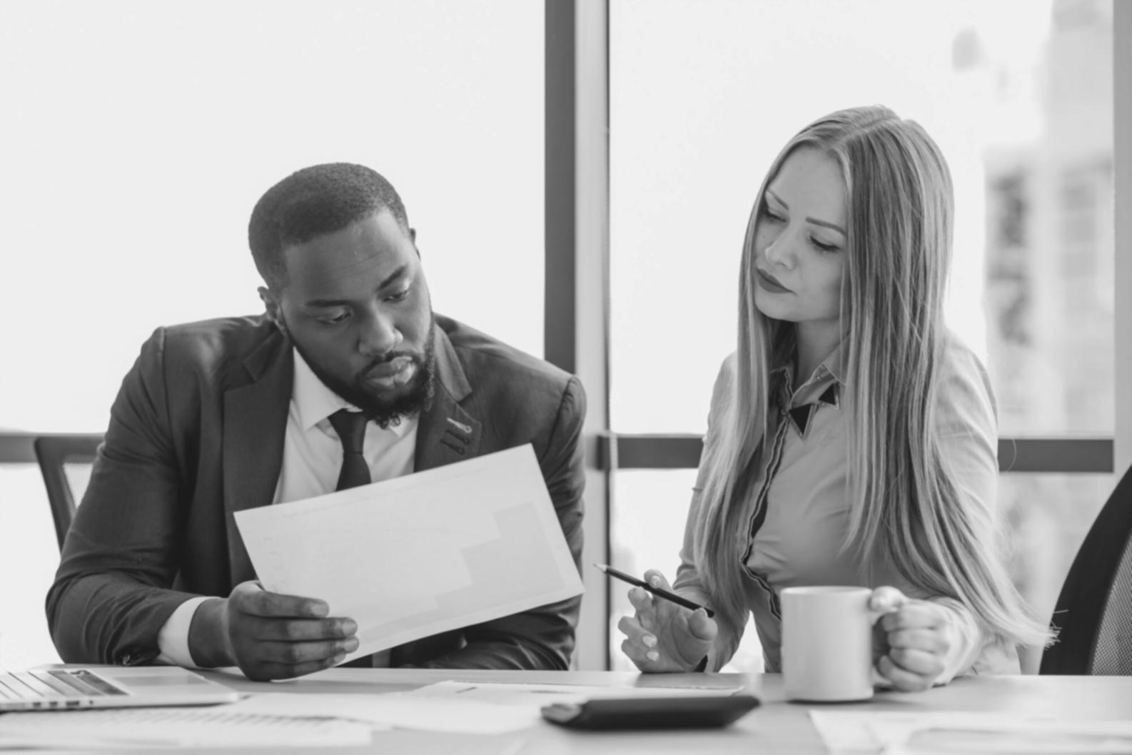 Professional business consultation meeting with documents and analysis charts