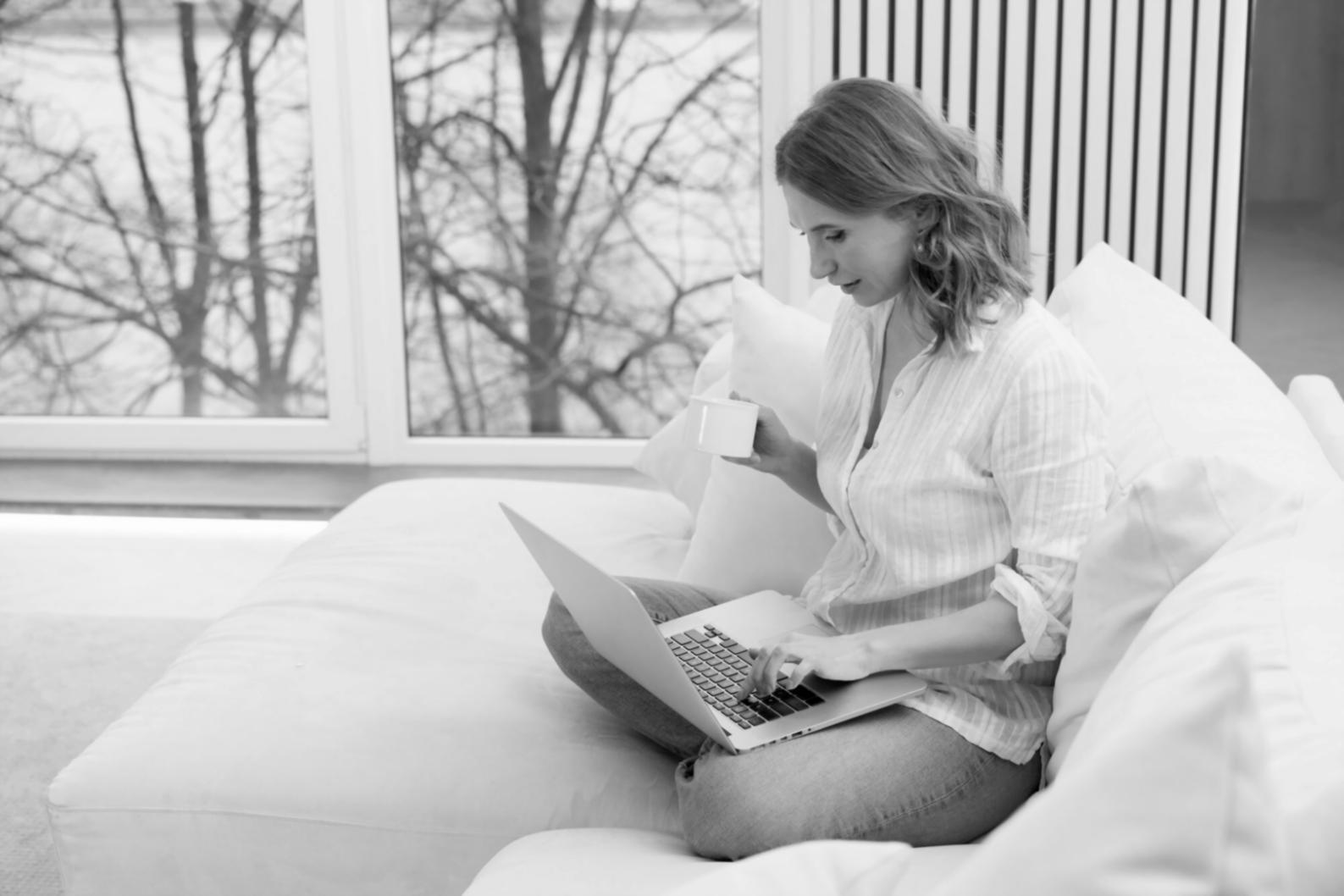Business analyst reviewing financial reports with calculator and spreadsheets on desk