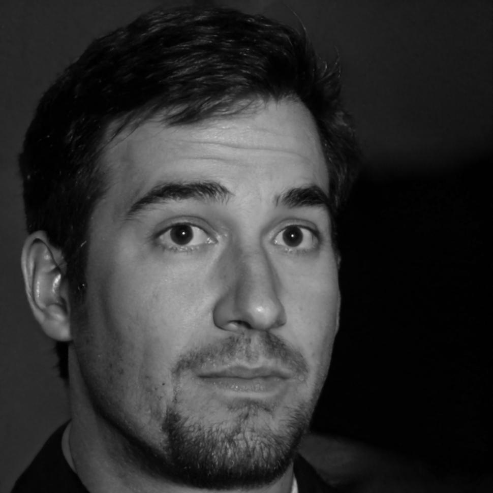 Experienced financial consultant Henrik Novak reviewing business documents